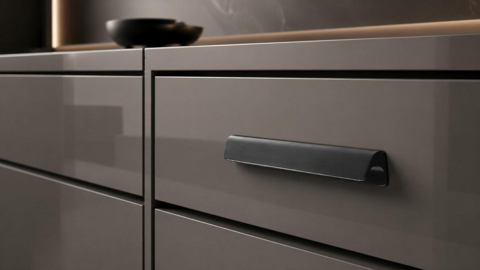 Luxury close-up of a glossy grey wardrobe drawer fitted with a sleek Mello handle